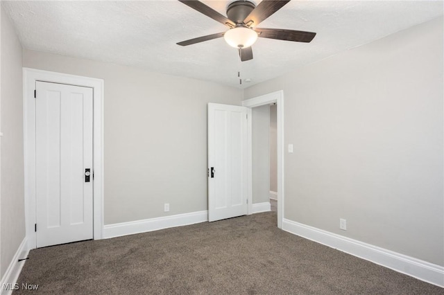 unfurnished bedroom with carpet flooring, ceiling fan, and baseboards