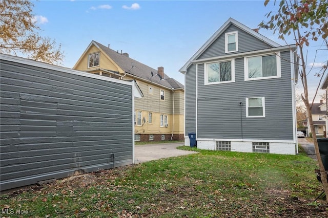 back of property with a patio and a yard