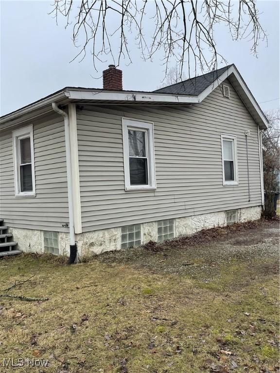 view of side of home with a chimney