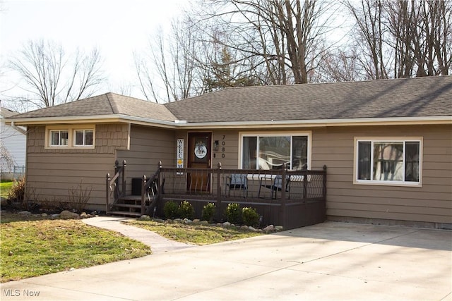 single story home with covered porch, driveway, and a shingled roof