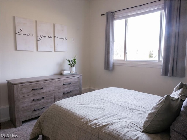 carpeted bedroom featuring baseboards