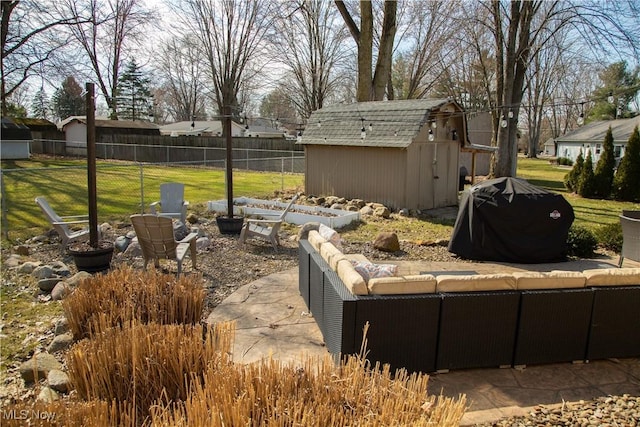 view of yard with a storage unit, an outbuilding, fence, an outdoor hangout area, and a patio area