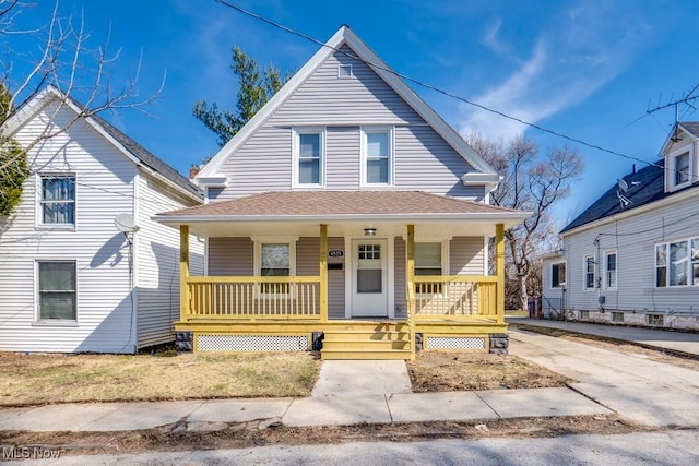 view of front of house featuring roof with shingles and a porch