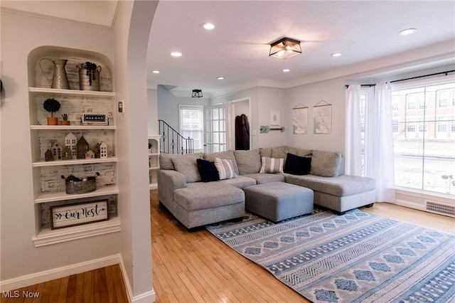 living room with visible vents, baseboards, stairs, recessed lighting, and wood finished floors