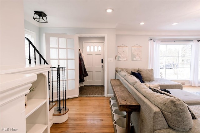 living area featuring a wealth of natural light, recessed lighting, and light wood-style flooring