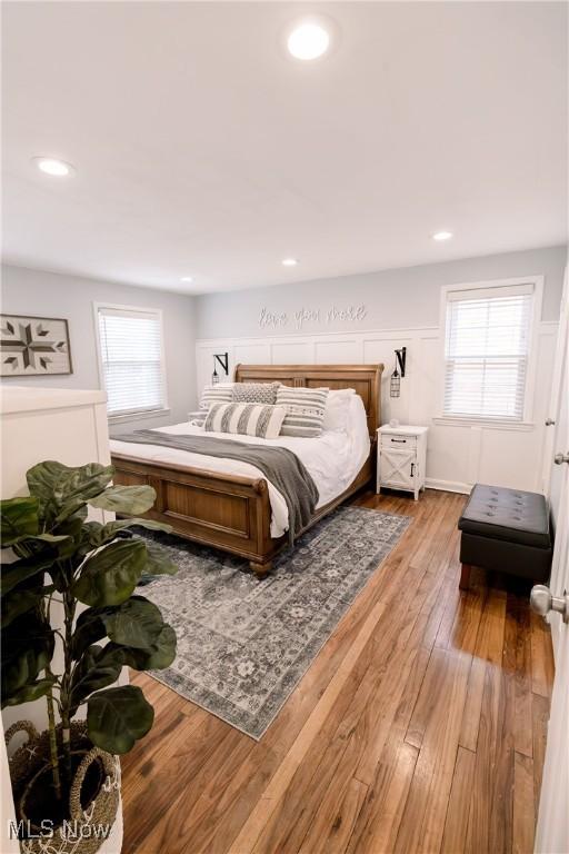 bedroom featuring recessed lighting, multiple windows, and light wood-style floors