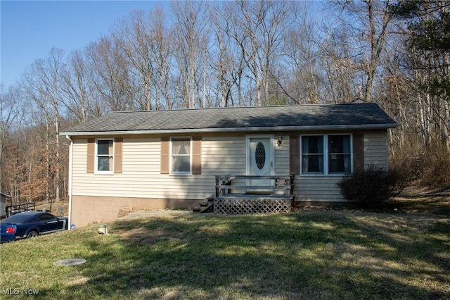 ranch-style house with a wooden deck and a front yard