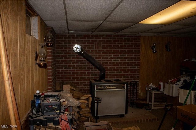 interior space featuring wooden walls and a paneled ceiling