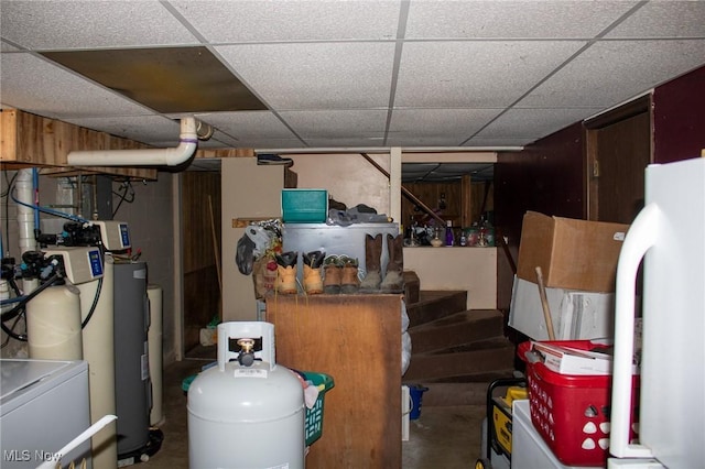 finished below grade area featuring refrigerator and a paneled ceiling