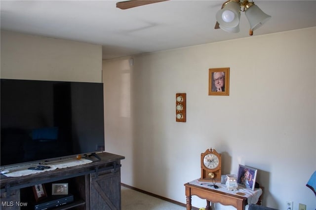 interior space with light colored carpet, baseboards, and a ceiling fan