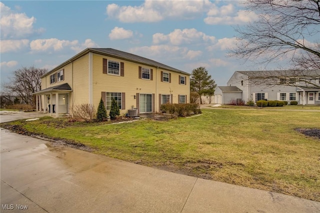 colonial house with a front lawn and central AC unit