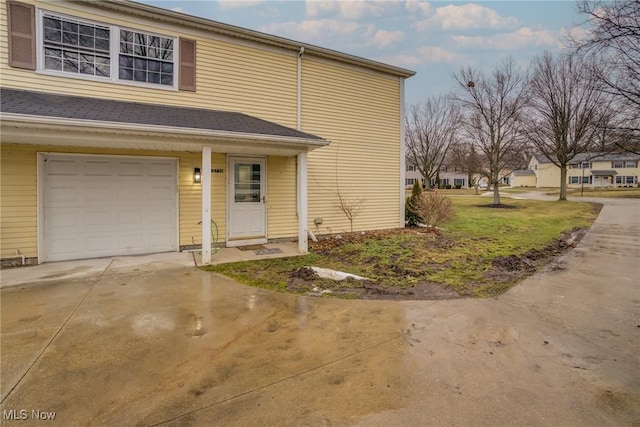 view of front of property with concrete driveway and a garage