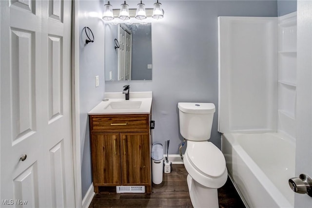 bathroom featuring visible vents, toilet, wood finished floors, baseboards, and vanity