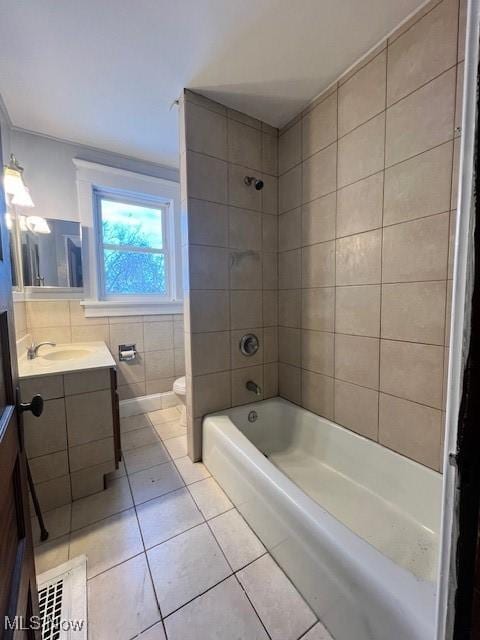 bathroom with toilet, shower / washtub combination, tile walls, tile patterned flooring, and vanity