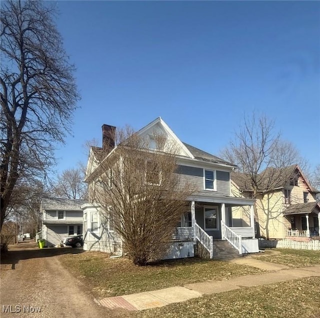 716 N Ave NE, Massillon, OH 44646 - view of front facade with driveway, covered porch, and a chimney