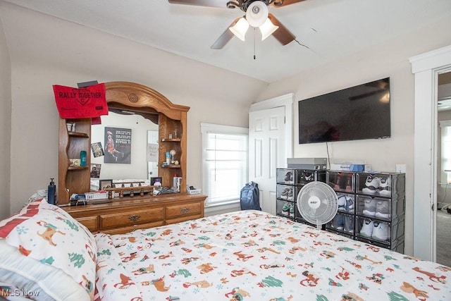 bedroom with a ceiling fan and vaulted ceiling