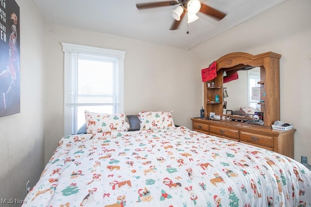 bedroom featuring a ceiling fan and lofted ceiling