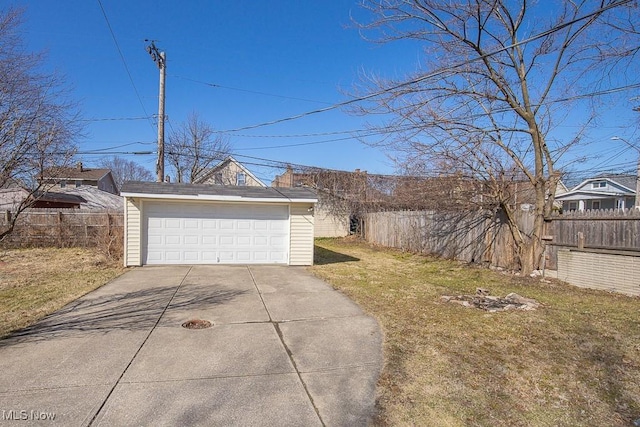 view of yard featuring a garage, an outdoor structure, and fence