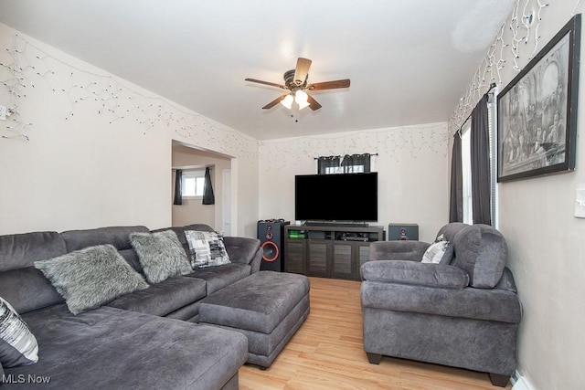 living area featuring a ceiling fan and light wood finished floors