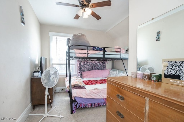 bedroom with a ceiling fan, baseboards, and light carpet