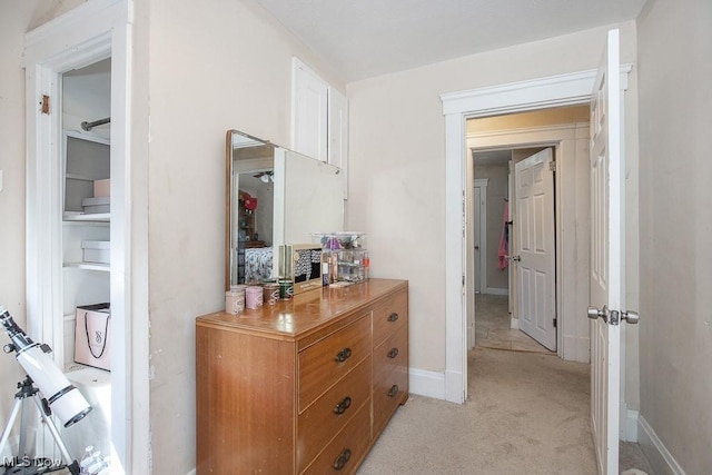 corridor with light carpet and baseboards