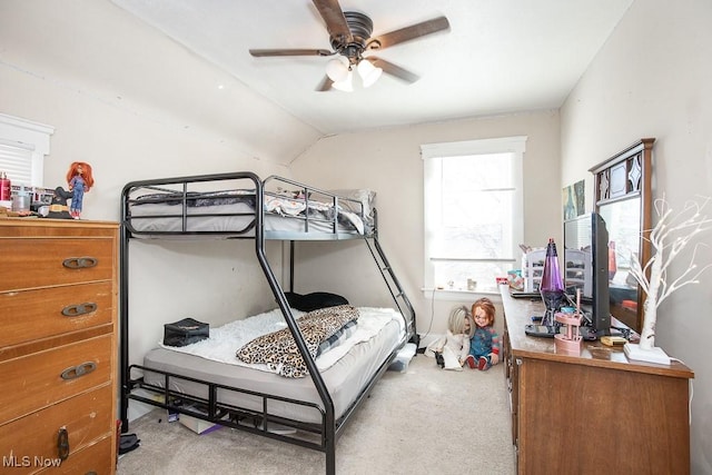 carpeted bedroom featuring ceiling fan and vaulted ceiling