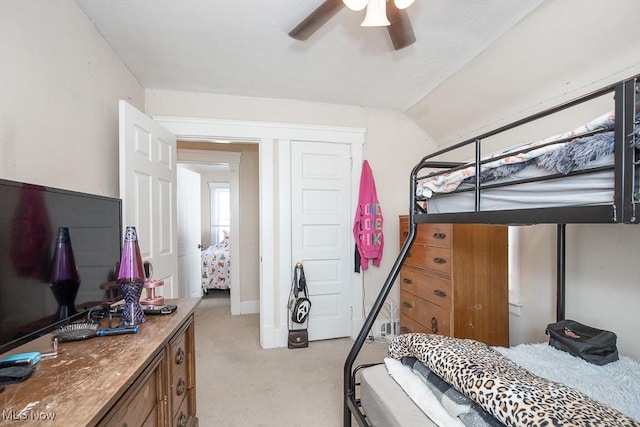 bedroom with light carpet, ceiling fan, and vaulted ceiling