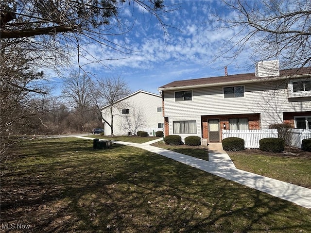 exterior space with a front yard and fence