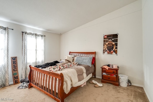 bedroom with baseboards, lofted ceiling, and carpet floors