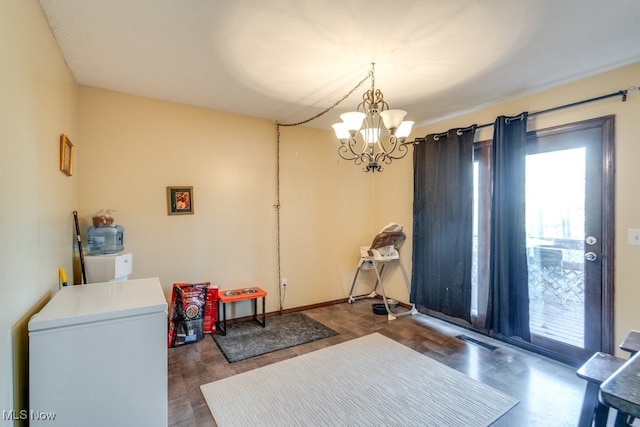 interior space featuring visible vents, a notable chandelier, a healthy amount of sunlight, and wood finished floors