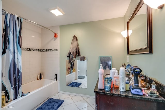 full bathroom with tile patterned flooring, shower / bath combo with shower curtain, vanity, and baseboards