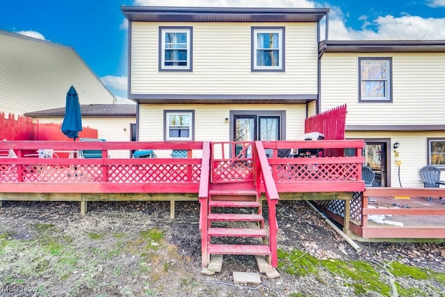 rear view of property featuring a deck