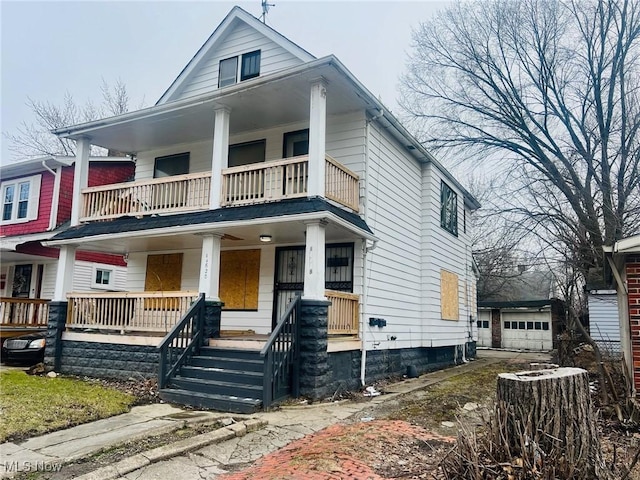 view of front facade featuring a porch, a balcony, and central AC