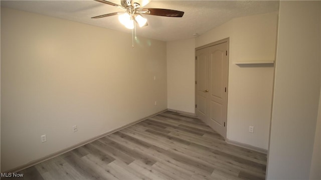 355 Village Pointe Dr Unit 1-A, Akron, OH 44313 - unfurnished bedroom with baseboards, light wood-type flooring, a closet, and ceiling fan