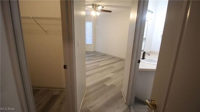 355 Village Pointe Dr Unit 1-A, Akron, OH 44313 - hall with light wood finished floors, baseboards, and a sink