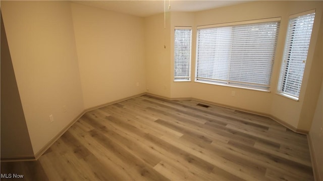 355 Village Pointe Dr Unit 1-A, Akron, OH 44313 - spare room featuring visible vents, baseboards, and wood finished floors
