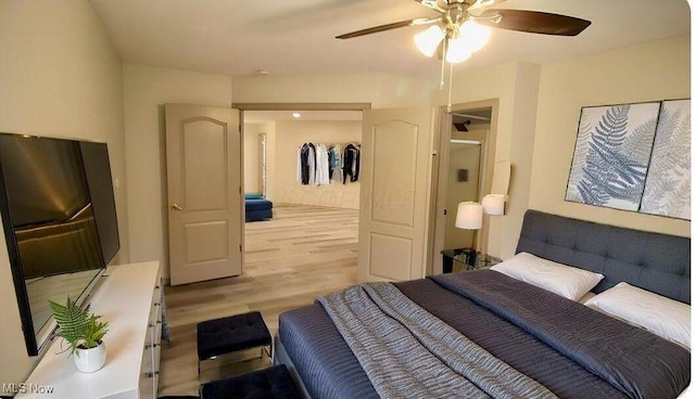 355 Village Pointe Dr Unit 1-A, Akron, OH 44313 - bedroom with light wood-style floors and ceiling fan