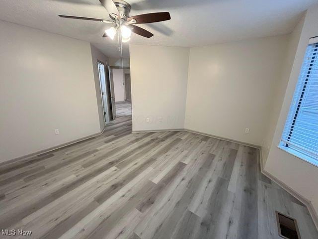 355 Village Pointe Dr Unit 1-A, Akron, OH 44313 - empty room featuring visible vents, light wood finished floors, and ceiling fan