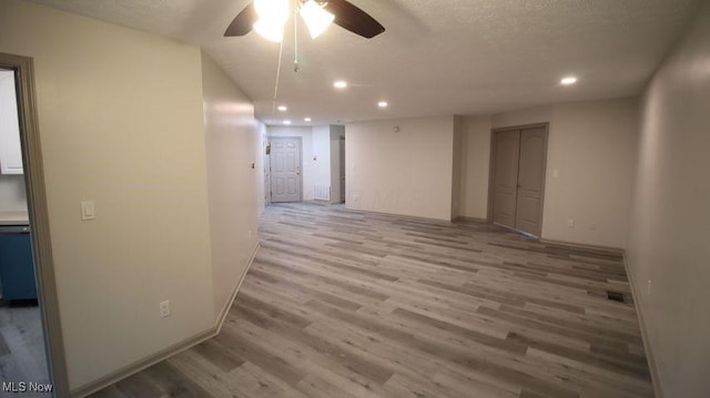 355 Village Pointe Dr Unit 1-A, Akron, OH 44313 - empty room featuring ceiling fan, recessed lighting, light wood-type flooring, and baseboards