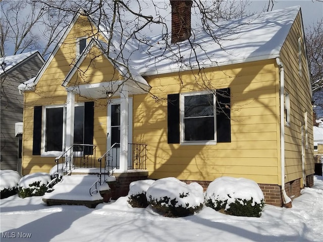 view of snow covered rear of property