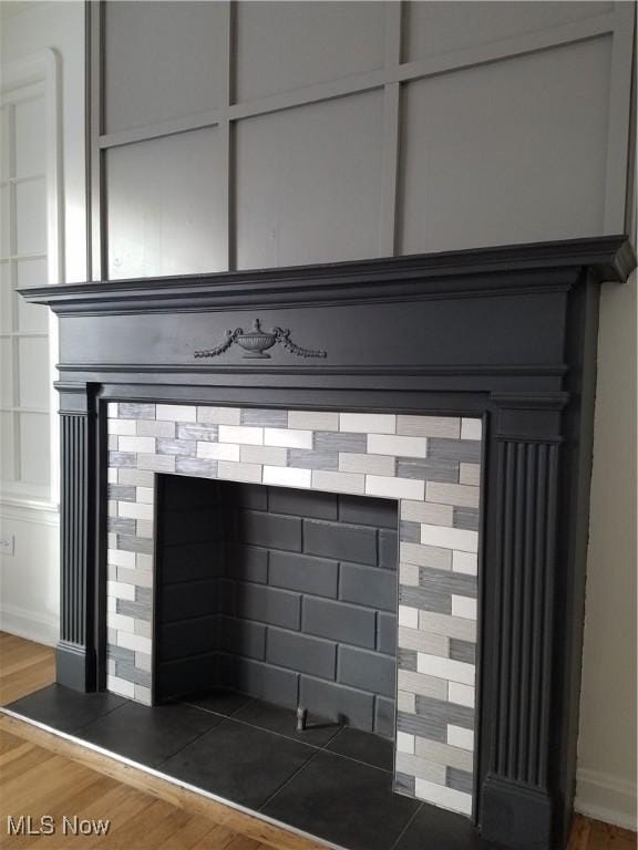 interior details with a fireplace and wood finished floors