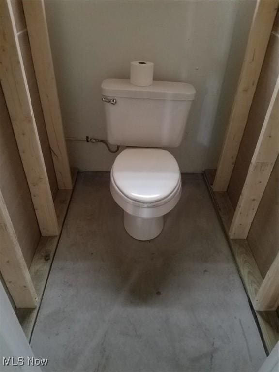 bathroom with toilet and concrete floors