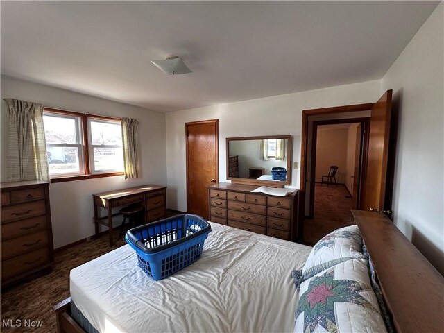 bedroom with dark colored carpet