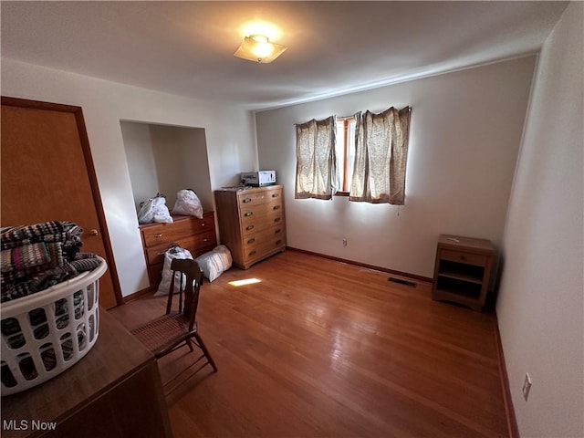 bedroom featuring visible vents, baseboards, and light wood-style floors