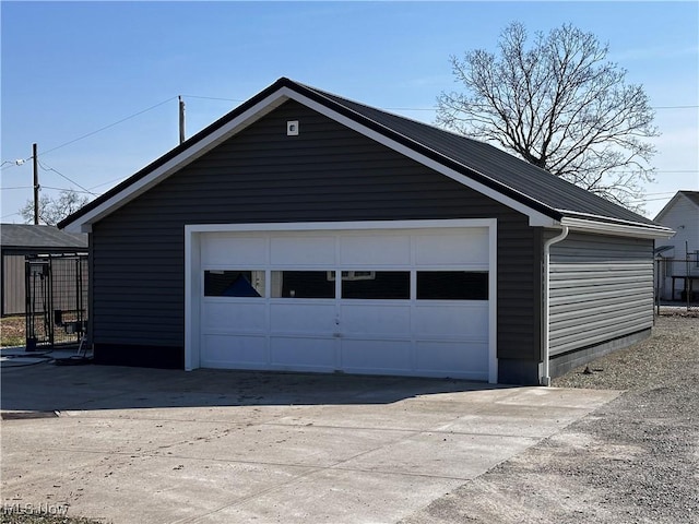 detached garage with concrete driveway