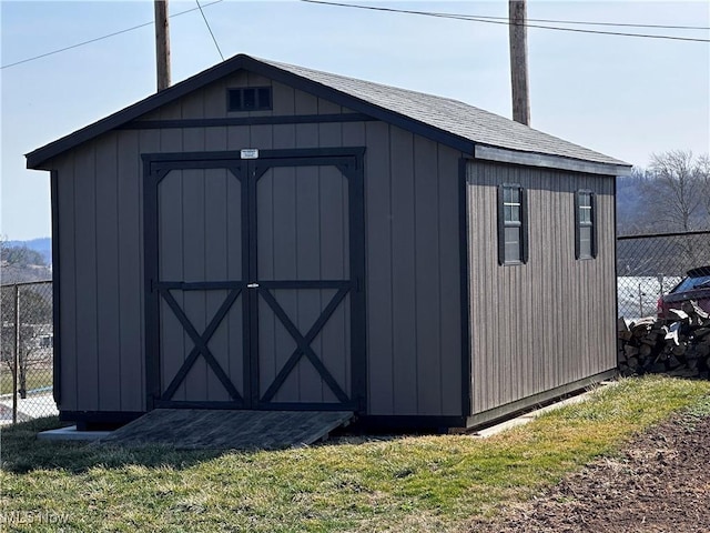 view of shed featuring fence