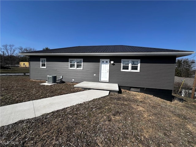 rear view of property featuring cooling unit