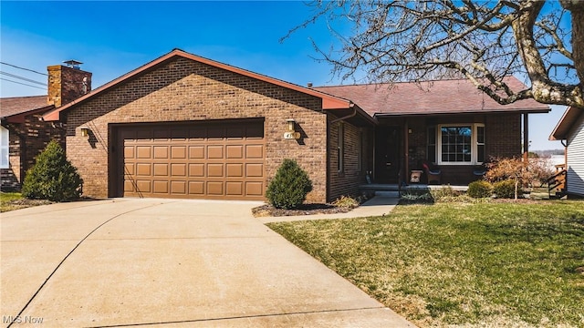 ranch-style house featuring a garage, driveway, brick siding, and a front yard