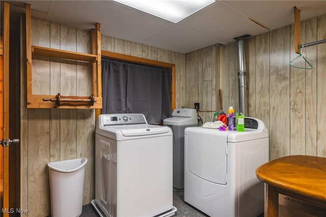 washroom with wooden walls and washer and dryer