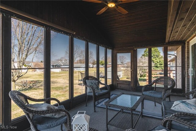 sunroom with wood ceiling, ceiling fan, and vaulted ceiling